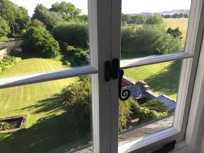 an open window with a view of a yard at Aberllynfi Riverside Guest House in Glasbury