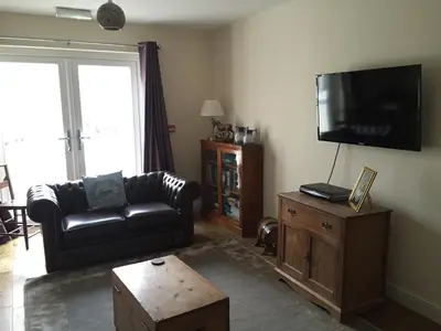 a living room with a couch and a flat screen tv at Bro Dafydd in Aberystwyth