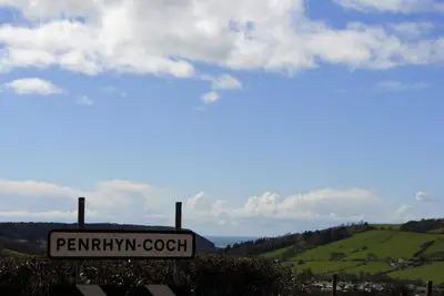 a sign that reads pennymaugh coach on a hill at Bro Dafydd in Aberystwyth