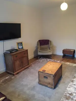 a living room with a tv and a coffee table at Bro Dafydd in Aberystwyth