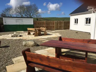 a picnic table and benches in a yard at Bro Dafydd in Aberystwyth