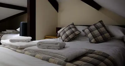 a bedroom with two towels on a bed at Mid Wales Holiday Lets, Rhayader in Rhayader