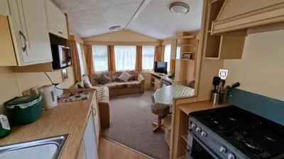 a small kitchen and living room in a caravan at Dinas in Llanbedr
