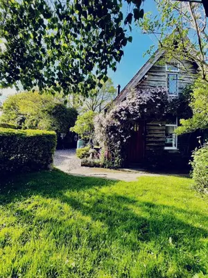 an old house with a green yard in front of it at Parrs cottage in Wollaston
