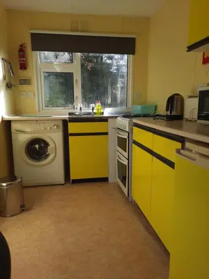 a kitchen with a sink and a washing machine at Cerdyn Villa in Llanwrtyd Wells
