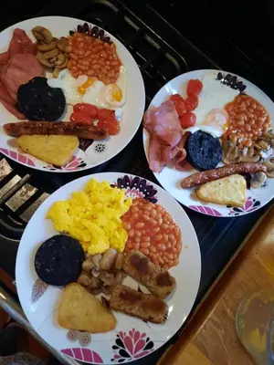 four plates with different types of breakfast foods on them at Cerdyn Villa in Llanwrtyd Wells