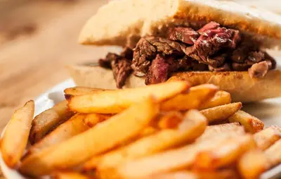 a sandwich and french fries on a plate at Gales Of Llangollen in Llangollen