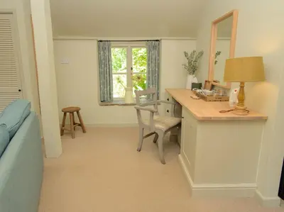 a living room with a desk and a window at Riverside Inn, Aymestrey in Aymestrey