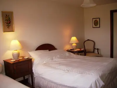 a bedroom with a large white bed with two lamps at Highfield in Hay-on-Wye