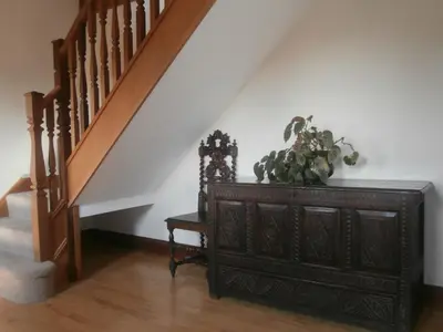 a room with a dresser and a staircase with a plant on it at Highfield in Hay-on-Wye