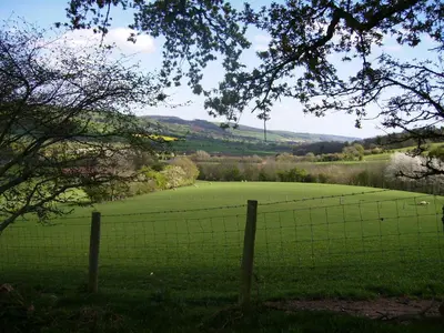 a fence in front of a green field at Highfield in Hay-on-Wye