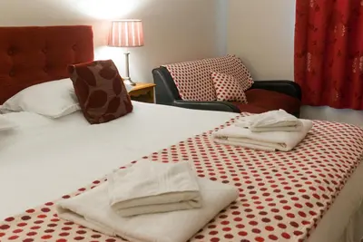 a hotel room with two towels on a bed at The Dragon Hotel in Montgomery