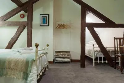 a bedroom with a bed in a room with wooden beams at The Dragon Hotel in Montgomery