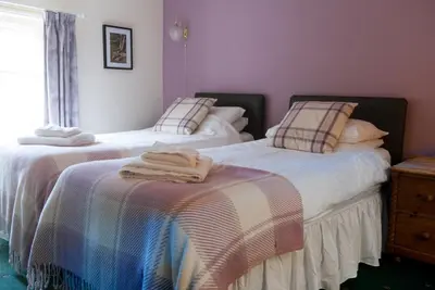 a bedroom with two beds with towels on them at The Dragon Hotel in Montgomery