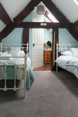 a bedroom with two beds in a attic at The Dragon Hotel in Montgomery