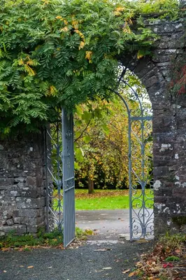 an entrance to a garden with an iron gate at Llangoed Hall in Bronllys
