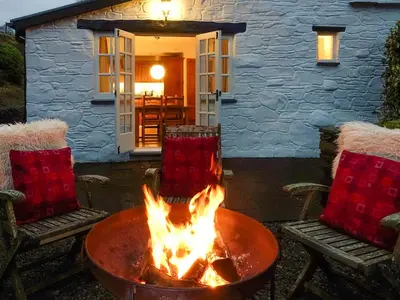 a fire pit in front of a house at Ty'n Y Ffordd in Llanymawddwy