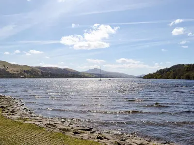 a large body of water with a sail boat in it at Y Bwthyn in Bala