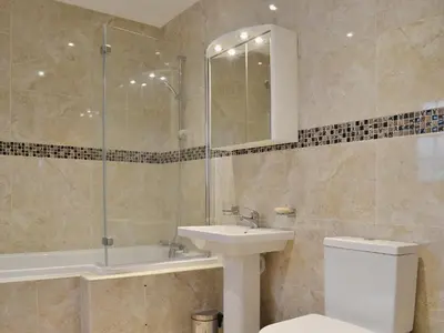 a bathroom with a toilet and a sink and a shower at Maes Rheidol in Capel Bangor