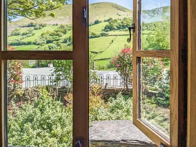 an open window with a view of a house at Yr Efail - Hw7387 in Llanymawddwy