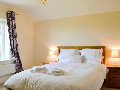 a bedroom with a bed with two towels on it at Cefnaire in Newtown
