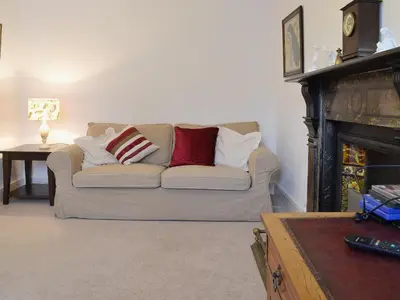 a living room with a couch and a fireplace at The Old Post Office in Myddfai