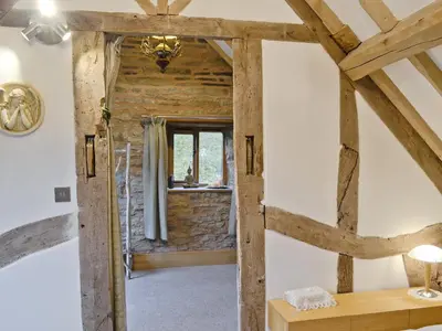 an open door into a room with wooden beams at Acorn Cottage in Croft