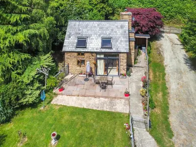 an aerial view of a stone house with a yard at Acorn Cottage in Croft