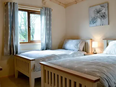 a bedroom with two twin beds and a window at Callow Lodge in Meadowtown