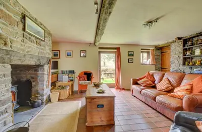 a living room with a couch and a fireplace at 2 Bed in Brecon oc-37318 in Pentre-bâch
