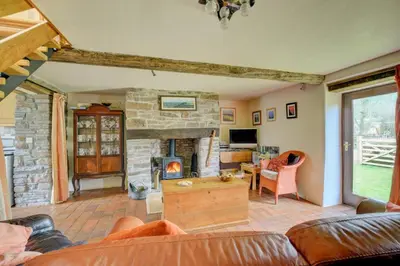 a living room with a couch and a fireplace at 2 Bed in Brecon oc-37318 in Pentre-bâch