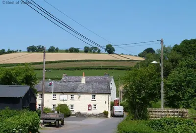 a white house in the middle of a field at 2 Bed in Brecon oc-37318 in Pentre-bâch