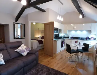 a living room and kitchen with a couch and a table at Becws Clyd in Trawsfynydd