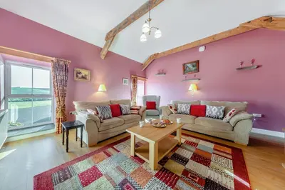 a living room with two couches and a table at 3 Bed in Aberystwyth oc-76692 in Llanilar