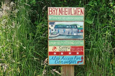 a sign in the grass with a building on it at 3 Bed in Aberystwyth oc-76692 in Llanilar