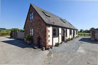 a brick building with white doors and windows at 1 Bed in Welshpool oc-75714 in Meifod