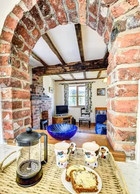 a room with a table with a cake on it at 1 Bed in Welshpool oc-75714 in Meifod