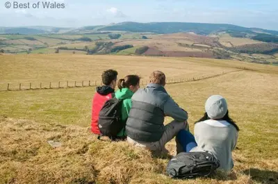 a group of people sitting on top of a hill at 2 Bed in Welshpool oc-75703 in Meifod