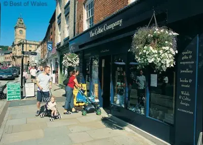 a family walking down a street with a baby in a stroller at 2 Bed in Welshpool oc-75703 in Meifod