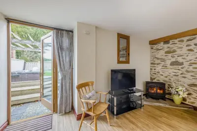 a living room with a chair and a fireplace at 4 Bed in Builth Wells oc-39461 in Builth Wells