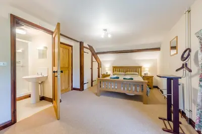 a bedroom with a bed and a sink at 4 Bed in Builth Wells oc-39461 in Builth Wells