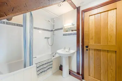 a bathroom with a sink and a tub and a toilet at 4 Bed in Builth Wells oc-39461 in Builth Wells