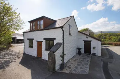 a small white building with a brown roof at 2 Bed in Aberdyfi oc-78258 in Pennal