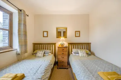 two twin beds in a bedroom with a mirror at 2 Bed in Builth Wells oc-39471 in Builth Wells