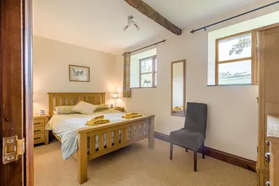 a bedroom with a bed and a desk and a chair at 2 Bed in Builth Wells oc-39471 in Builth Wells