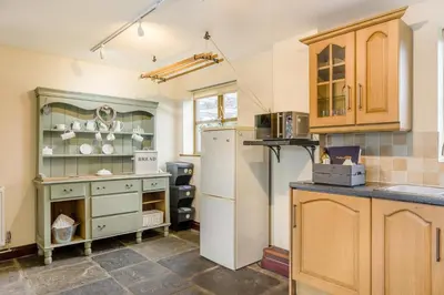 a kitchen with a refrigerator and a counter top at 4 Bed in Builth Wells oc-39473 in Builth Wells