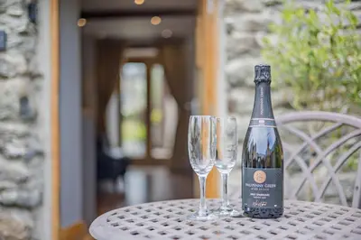 a bottle of wine sitting on a table with two glasses at 2 Bed in Bala oc-82212 in Bala