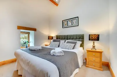 a bedroom with a large bed with towels on it at 2 Bed in Bala oc-82212 in Bala
