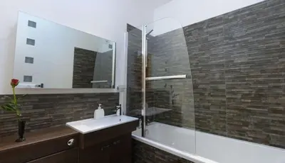 a bathroom with a sink and a tub and a mirror at 2 Bed in Bala oc-82212 in Bala