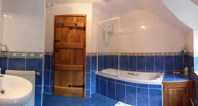 a bathroom with a tub and a sink at Troed yr Aran in Aber Cowarch